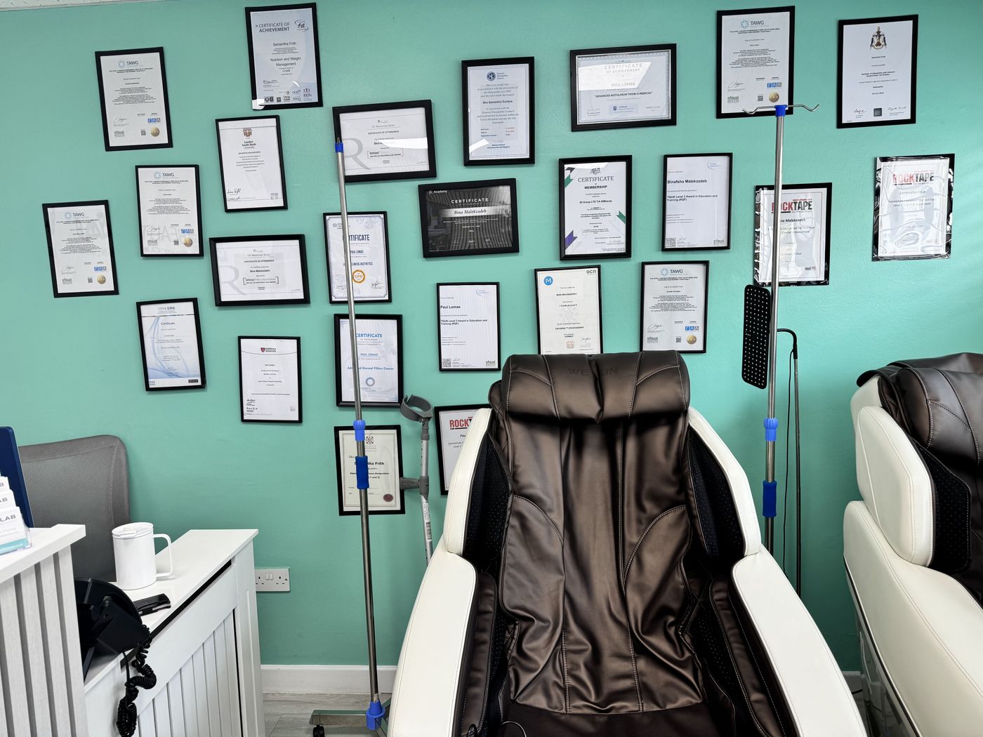 Certificates on the treatment room wall at 65Beauty Lab